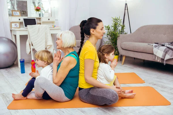 Pleasant calm nice family practicing yoga together — Stock Photo, Image