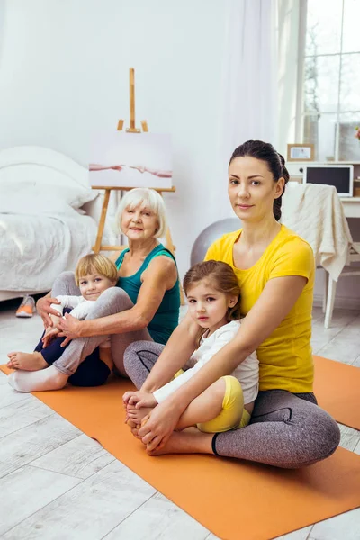 Positive sportive family sitting after the workout