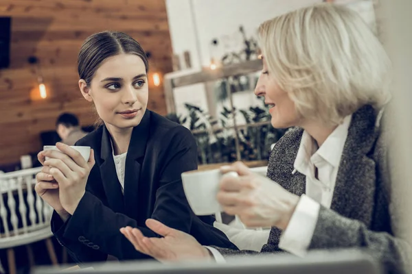 Young appealing daughter looking at her elegant beautiful mom — Stock Photo, Image