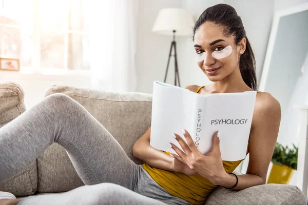 Positive delighted girl demonstrating her favorite book