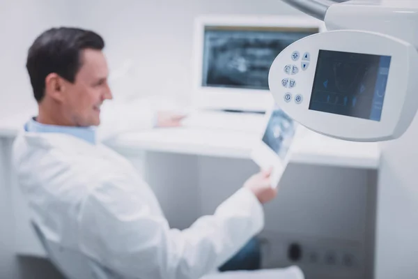 Silhouette of cheerful dentist that enjoying his job — Stock Photo, Image