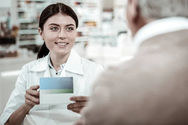 Rozpromieniony farmaceuty, zalecając dobre witaminy jej klienta — Zdjęcie stockowe