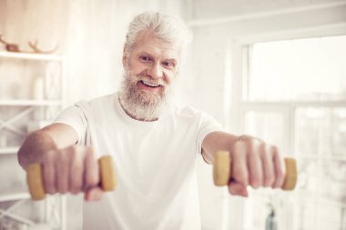 Tür gri saçlı erkek kişi zevkle spor yapıyor