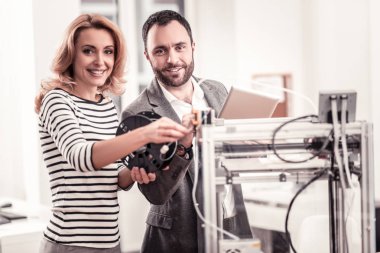 Pleasant colleagues working together at design project