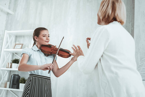 Delighted nice girl playing a music melody