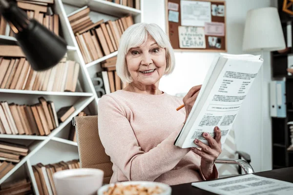 Cheerful retirement completing task for her classes — Stock Photo, Image