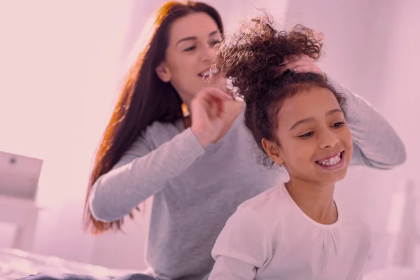 Happy nice girl having her ponytail done — Stockfoto