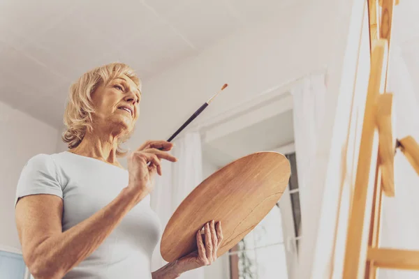 Delighted Painter Holding Brush Palette While Creating Picture — Stock Photo, Image