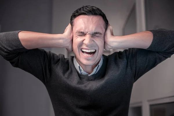Angry unhappy man having a very stressful job — Stock Photo, Image