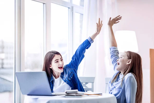 Energetic two girls giving high five after studying — Stock Fotó