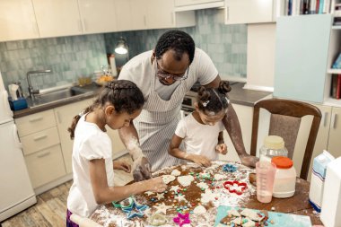 Çerezleri dekorasyon. Baba ve kızı onların Noel çerezleri dekorasyon üstten görünüm