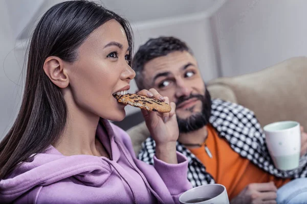 Couple aimant mignon manger des cookies et boire du thé devant la télévision — Photo