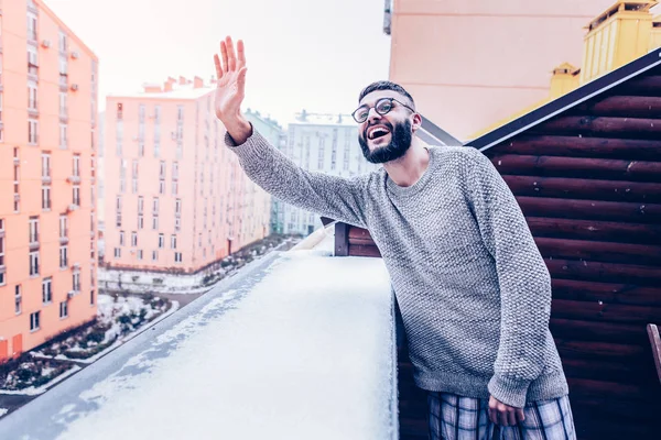Delighted positive man waving with his hand — Stock Photo, Image