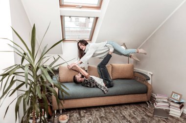 Delighted happy woman being held by her boyfriend