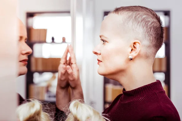 Concentrated bold female person being deep in thoughts — Stock Photo, Image