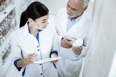 Yeni bir ilaç hakkında konuşurken bir eczane iki işçi