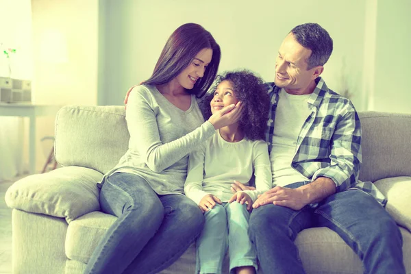 Caring responsible mom and dad expressing love to their daughter. — Stock Photo, Image