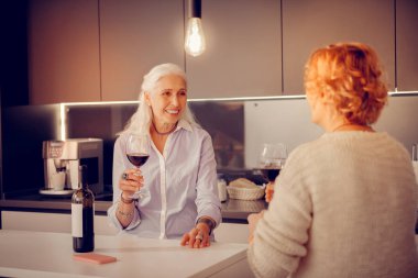 Bir bardak şarap ile duran neşeli neşeli kadın