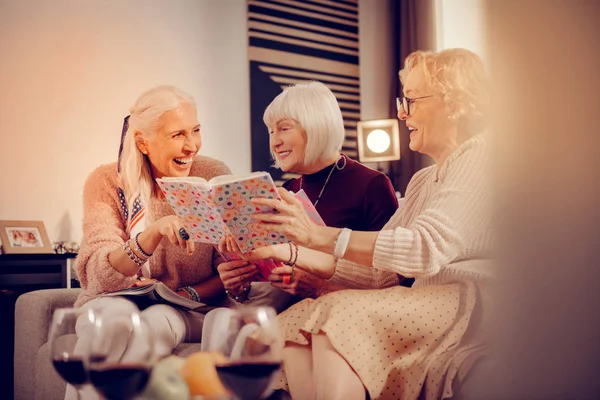 Delighted cheerful nice women enjoying reading books — Stock Photo, Image