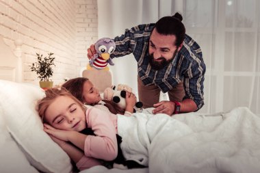 Olumlu memnun adam kabarık bir oyuncakla oynamak