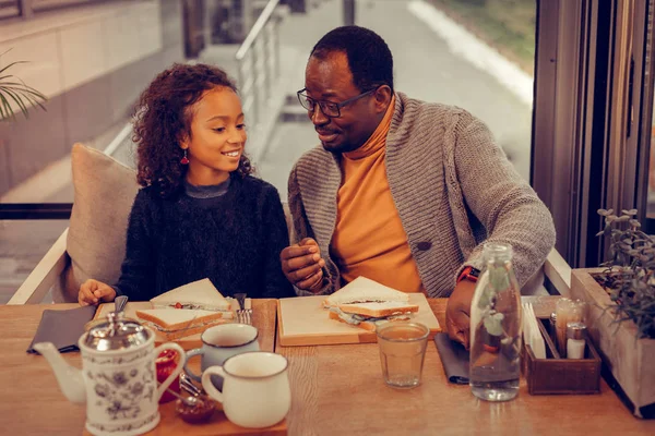 Father and daughter eating tasty sandwiches having lunch — Stock Photo, Image