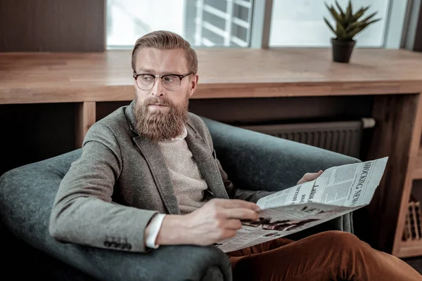 Serious male person having rest after meeting