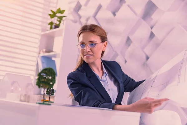 Orolig kvinna arkitekt kontrollera blåkopia på kontor — Stockfoto