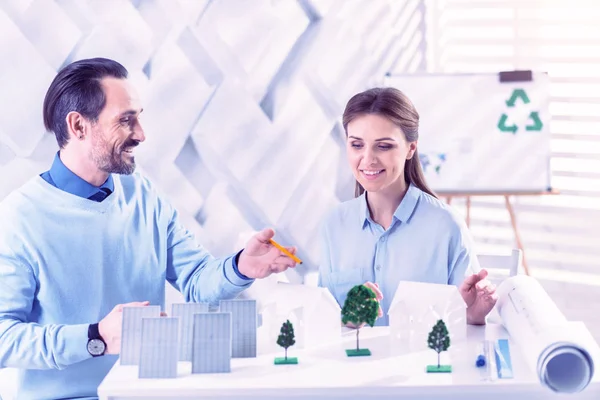 Diseñadores confiados sentados a la mesa y trabajando en el nuevo proyecto — Foto de Stock