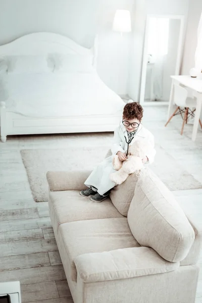 Positive delighted boy playing with his toy bear — Stock Photo, Image