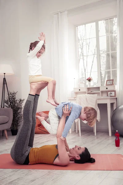 Mamma gör balanserande Yogaövning med sitt barn — Stockfoto