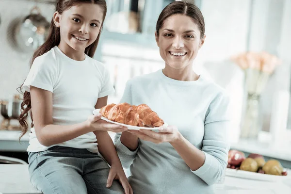 Orgulhoso mãe e filha tomando café da manhã na cozinha — Fotografia de Stock