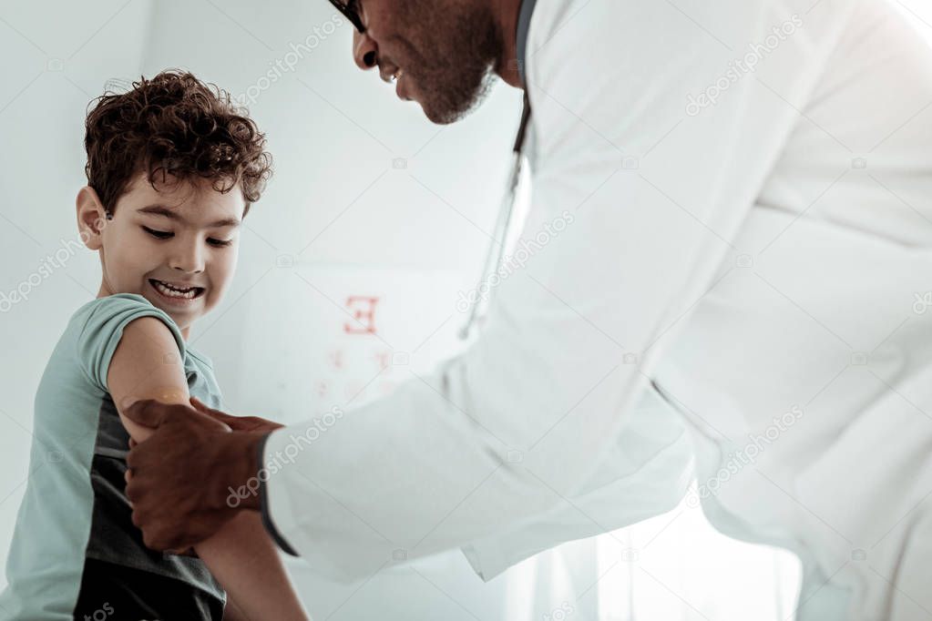 Brave kid staring at his sore arm