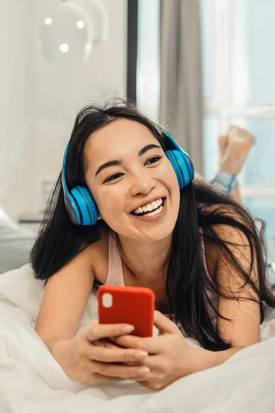 Woman feeling cheerful and relaxed while chilling at home