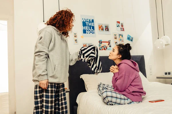 Curly roommate shouting at friend after finding her sweater