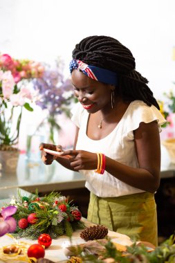 Şirin esmer genç çiçekçi alarak resmi telefon için