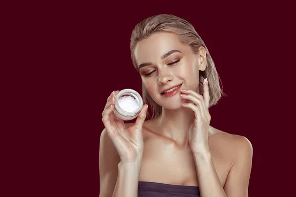 Blonďatá model s pěkný make-up prosazování cream — Stock fotografie