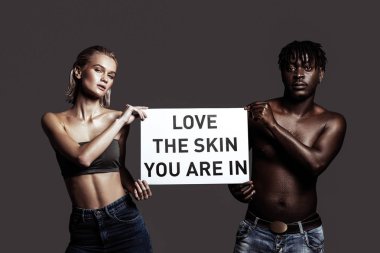 Slim model standing near her African-American boyfriend clipart