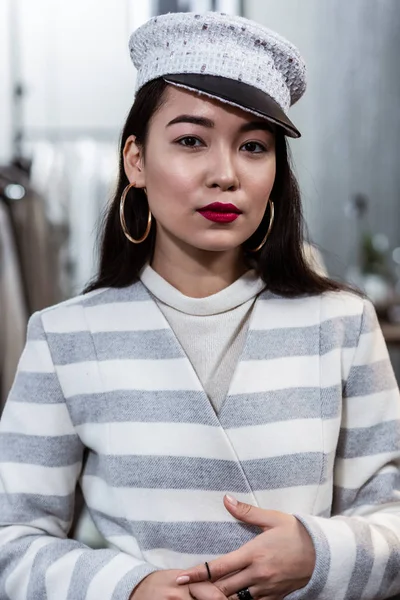 Young asian beaming woman with red lipstick looking contented — Stock Photo, Image