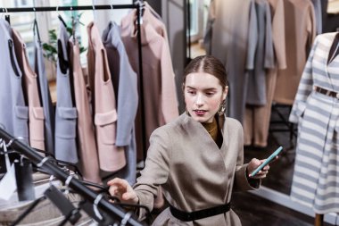 Büyük küpeler neşeli görünümlü şık elbiseli kadınla genç uzun saçlı güzel