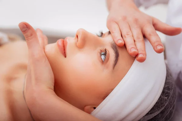 Face of a beautiful young woman during the massage — Stock Photo, Image