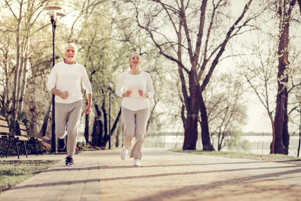 Positive delighted mature man doing active sport — Stock Photo, Image