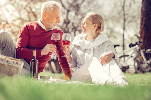 Charming mature woman drinking wine on picnic — Stock Photo, Image