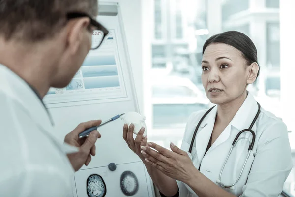 Kardiologin mit offenen Augen trägt Modell des Herzens — Stockfoto