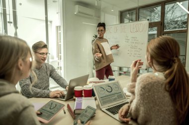 Duygu öğretmen öğrencilere yeni malzeme açıklayan heyecanlı