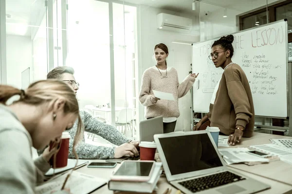 Students and teacher drinking coffee and discussing important moments