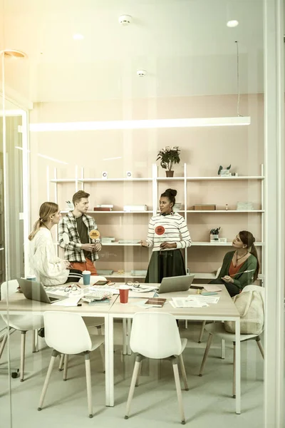 Content managers sitting in light office and using thinking hats — Stock Photo, Image