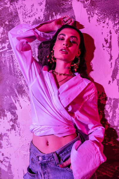 Nice beautiful young woman holding her hand up