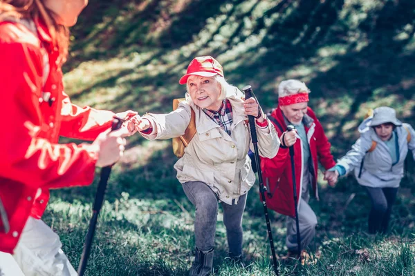 Active retired people hiking in natural park all together — Stock Photo, Image