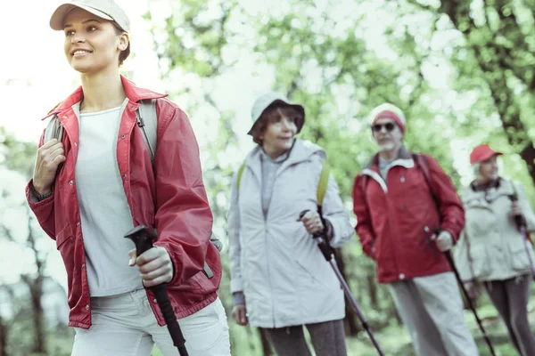 Group of people enjoying the outdoor walk in the forest — Stock Photo, Image