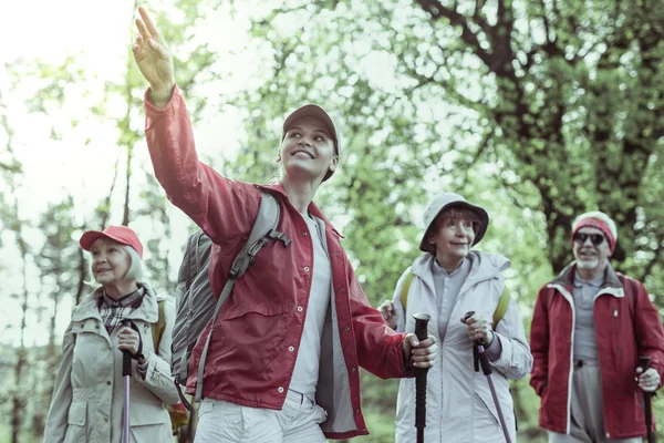 Woman making an excursion for the group of seniors